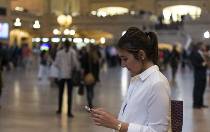 woman looking at her phone at grand central station in new york roy3775 2 5