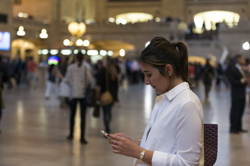 woman looking at her phone at grand central station in new york roy3775 2 5